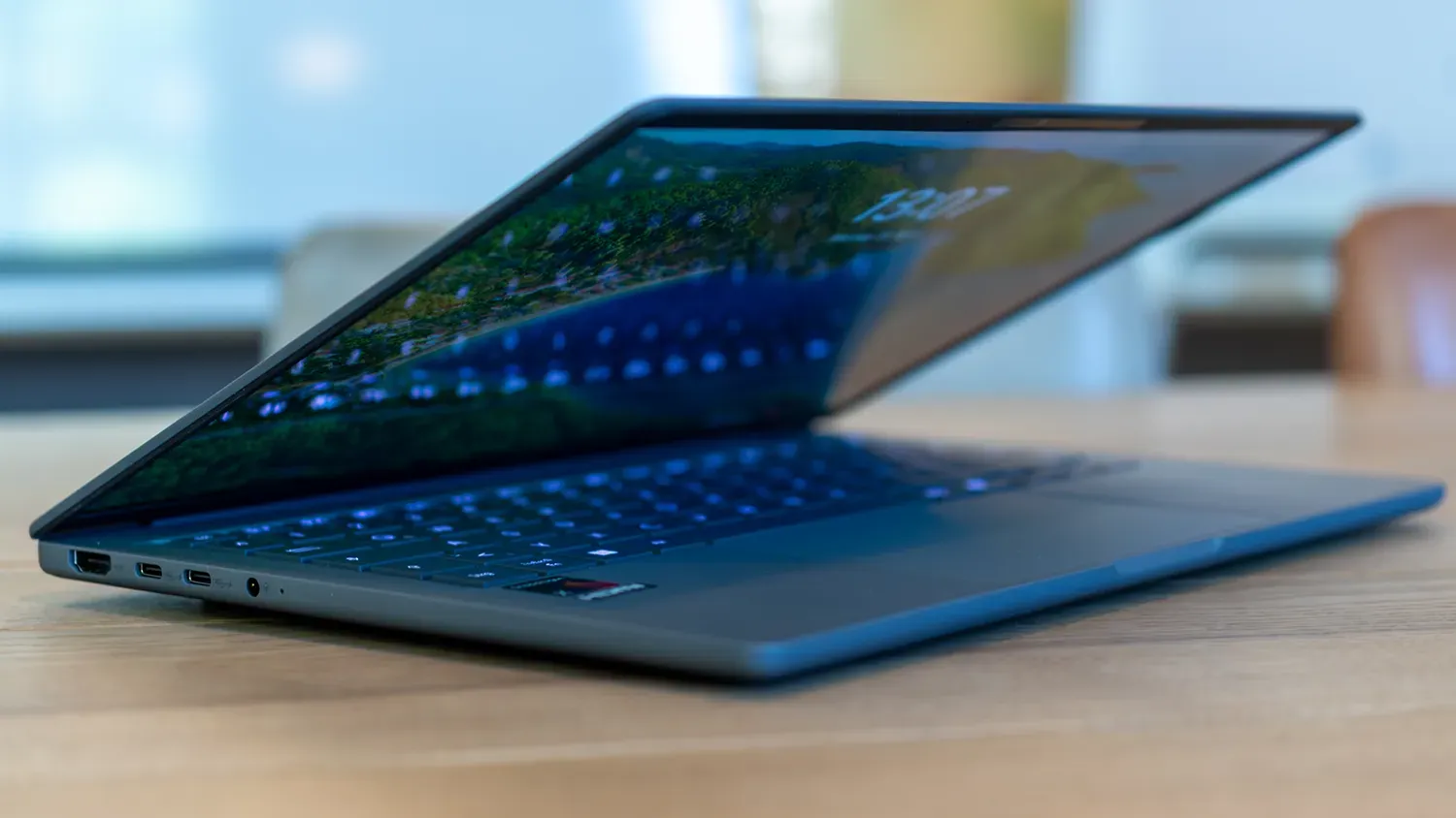 Schräg seitliche Sicht auf das Notebook mit halb geöffneten Displaydeckel